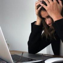 photo of stressed woman looking at laptop